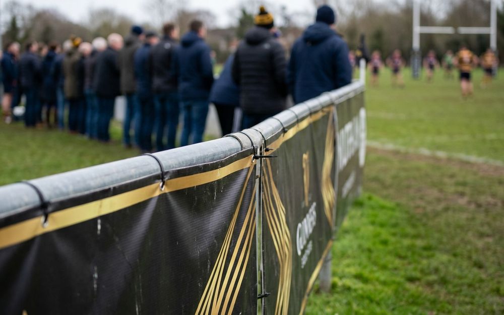 Pitchside sponsor banners around a local rugby pitch